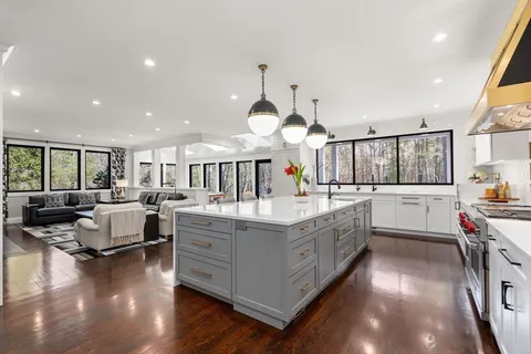 a view of a dining room with furniture and chandelier