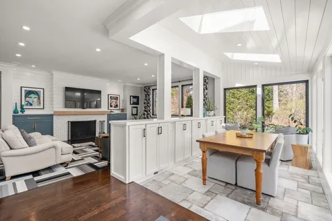 a room with fireplace furniture and a large window