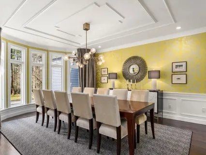 a view of a dining room with furniture and chandelier