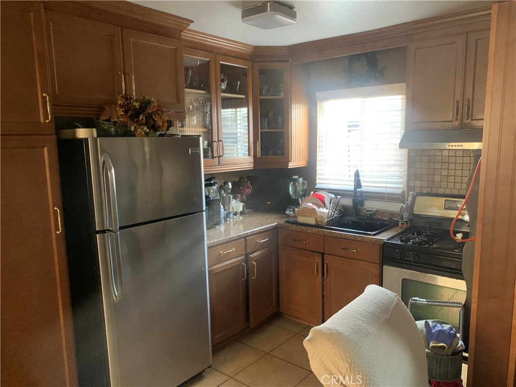 22414 Horst Avenue Hawaiian Gardens, CA 90716 - Photo 5 of 11 a kitchen with stainless steel appliances granite countertop a refrigerator sink and cabinets