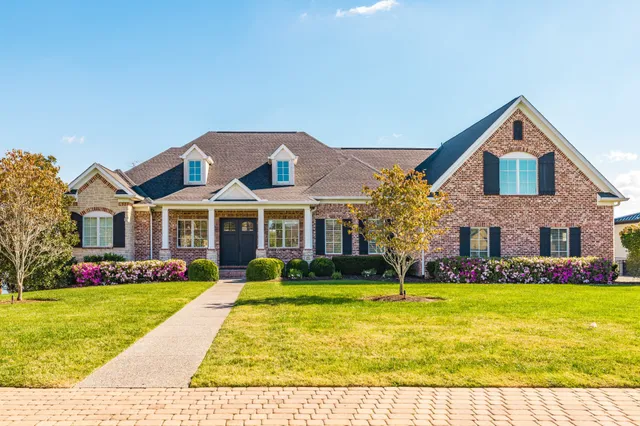 a front view of house with yard and green space