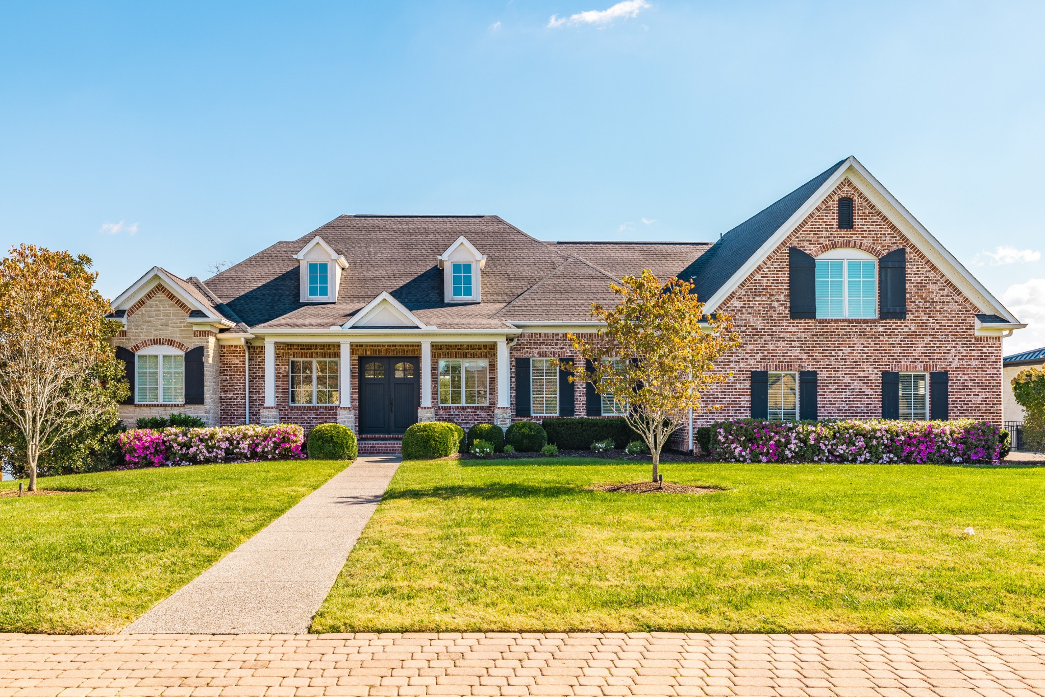 a front view of house with yard and green space