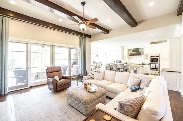 a kitchen with stainless steel appliances granite countertop a sink a stove counter top space and living room view