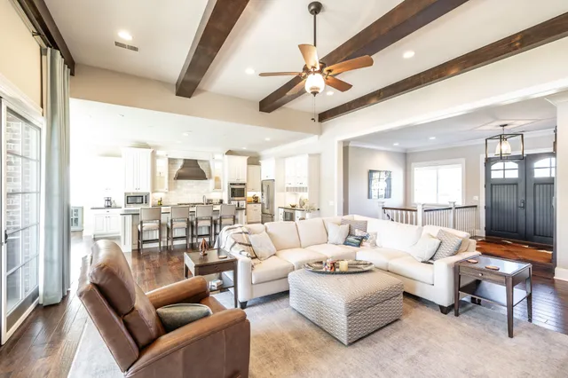 a dining room with furniture a chandelier and wooden floor
