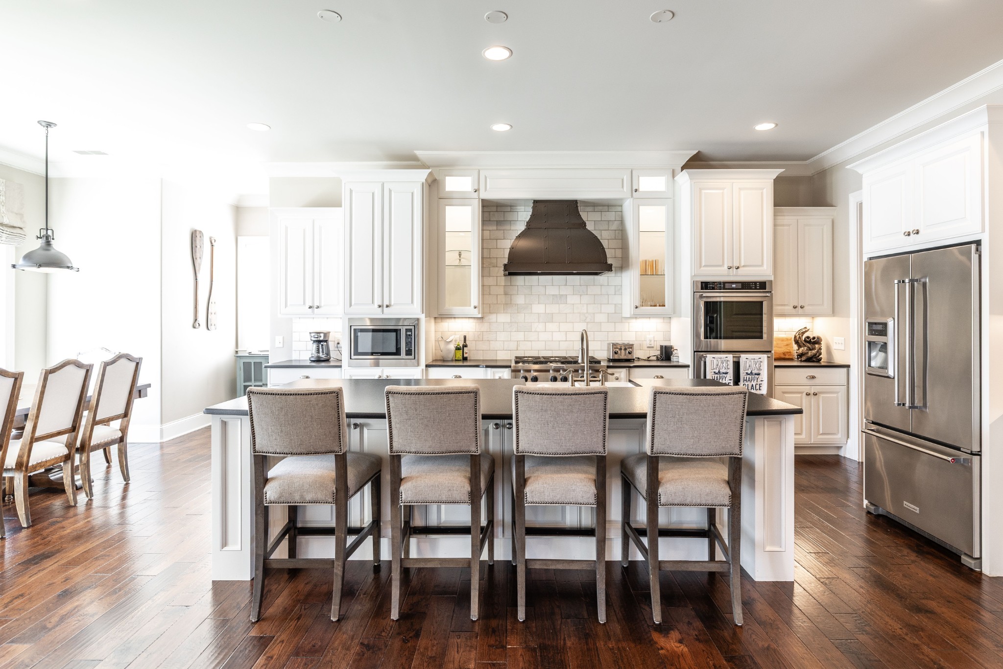 1395 Rozella Way Gallatin, TN 37066 - Photo 16 of 81 a kitchen with stainless steel appliances a dining table chairs refrigerator and sink