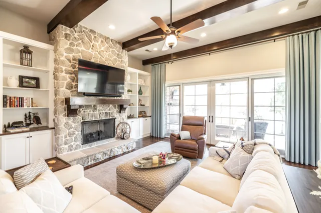a living room with furniture fireplace and a flat screen tv