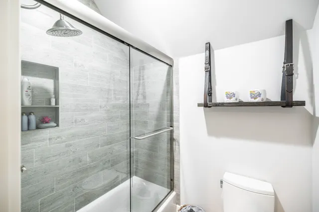a view of a house with a big yard potted plants and large tree