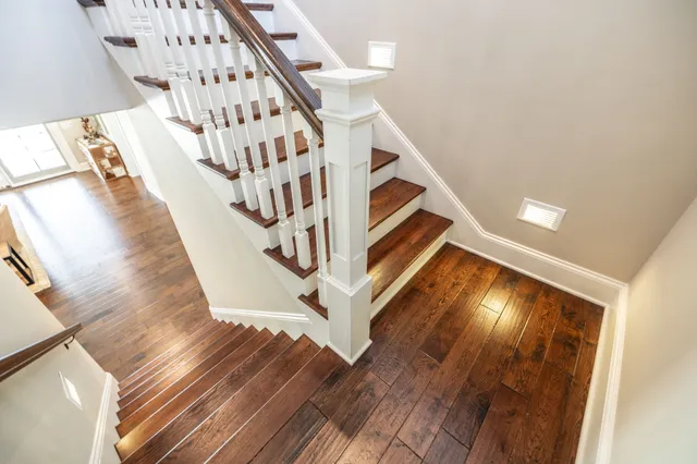an aerial view of ocean and residential houses with outdoor space