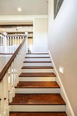 an aerial view of a house with swimming pool and large trees