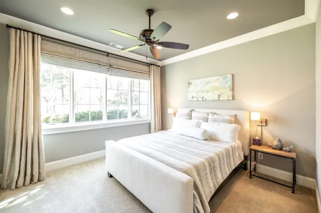 a view of a swimming pool with a lawn chairs under an umbrella