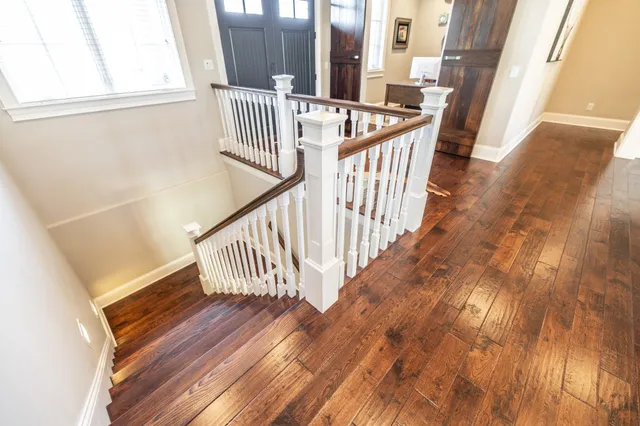 a living room with furniture ceiling fan and a large window