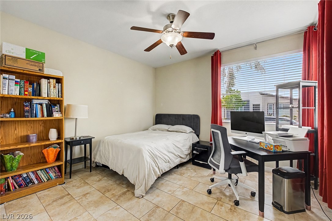 4914 East Beacon Ridge Drive Pahrump, NV 89061 - Photo 22 of 34 Functional bedroom featuring tile flooring and a ceiling fan, perfect for a versatile living space.