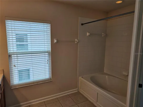 a bathroom with a tub and a shower