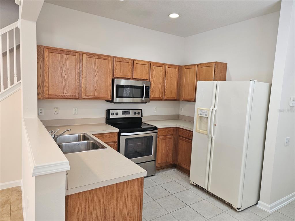 26638 Castleview Way Wesley Chapel, FL 33544 - Photo 6 of 24 a kitchen with a refrigerator sink and microwave