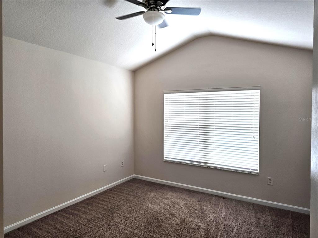 26638 Castleview Way Wesley Chapel, FL 33544 - Photo 8 of 24 an empty room with a window and a fan