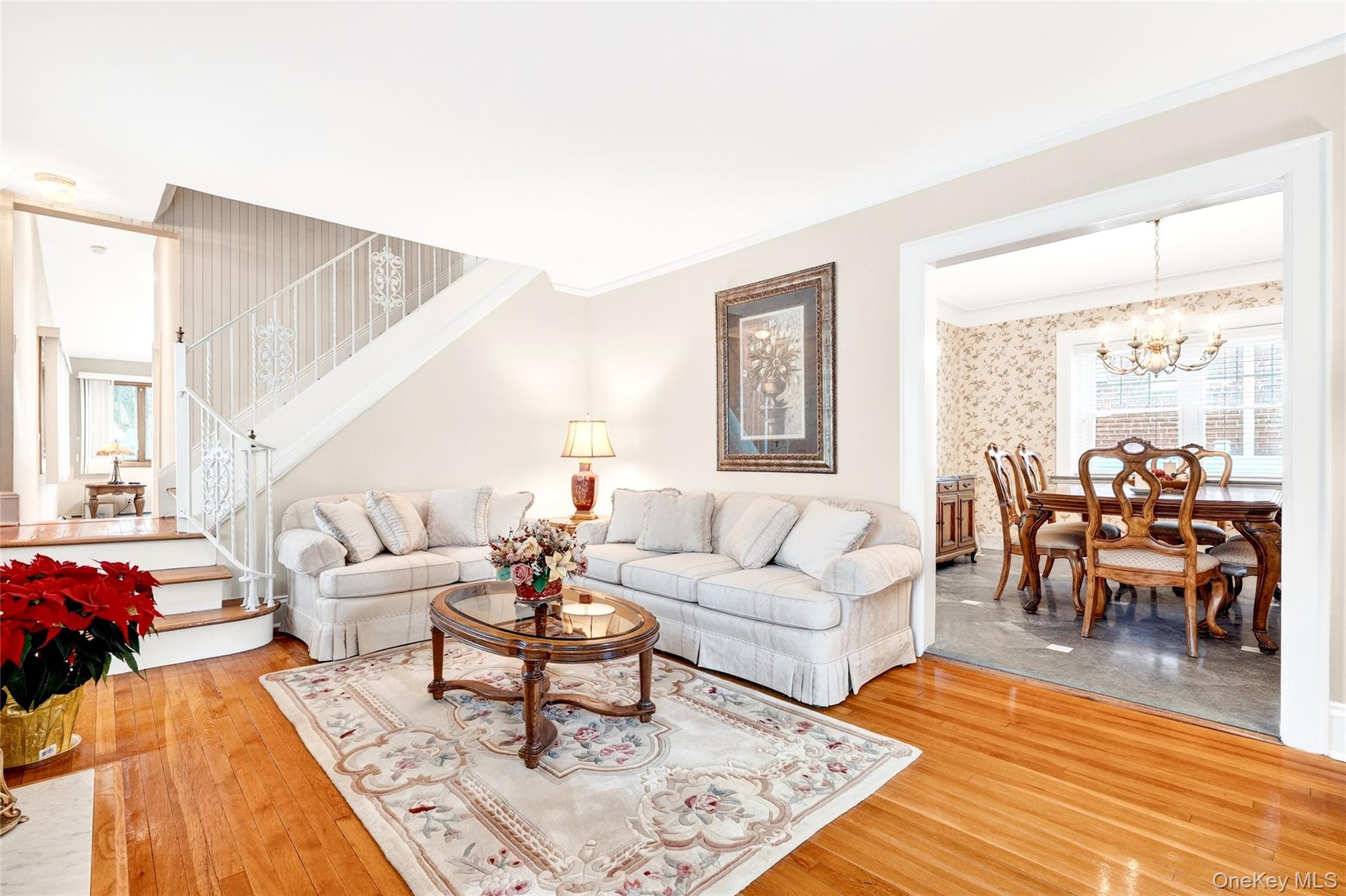 3334 Country Club Road Bronx, NY 10465 - Photo 10 of 49 Living area featuring crown molding, stairway, a chandelier, and wood-type flooring