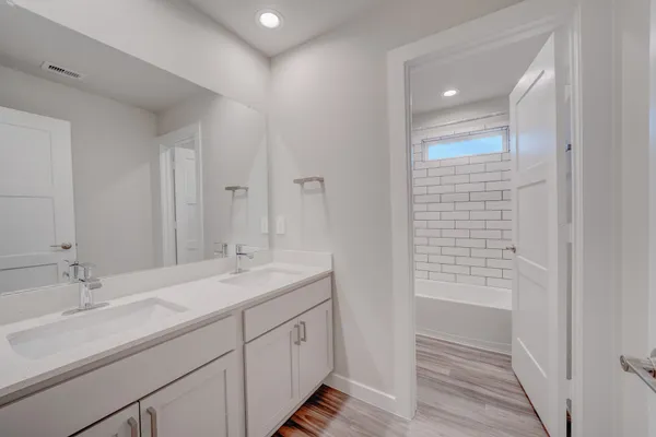 a bathroom with a sink double vanity and a mirror