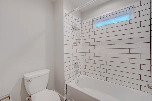 a bathroom with a bathtub and toilet