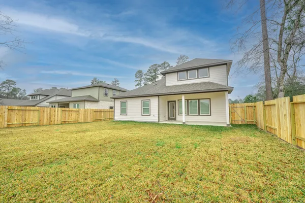 a front view of a house with a big yard