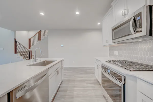 a kitchen that has a sink and a stove
