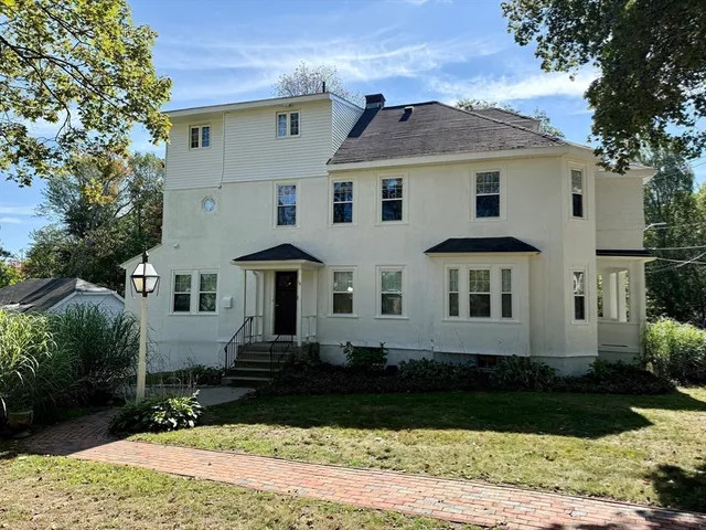 a front view of a house with a yard