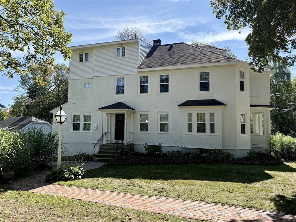 24 State Street, Unit 2 Wellesley, MA 02482 - Photo 1 of 21 a front view of a house with a yard