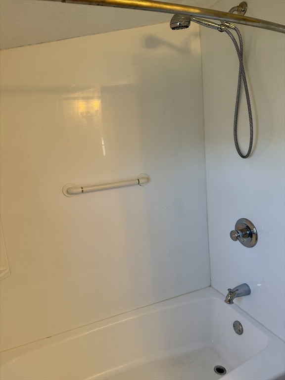24 State Street, Unit 2 Wellesley, MA 02482 - Photo 16 of 21 a bathroom with a bath tub with a shower