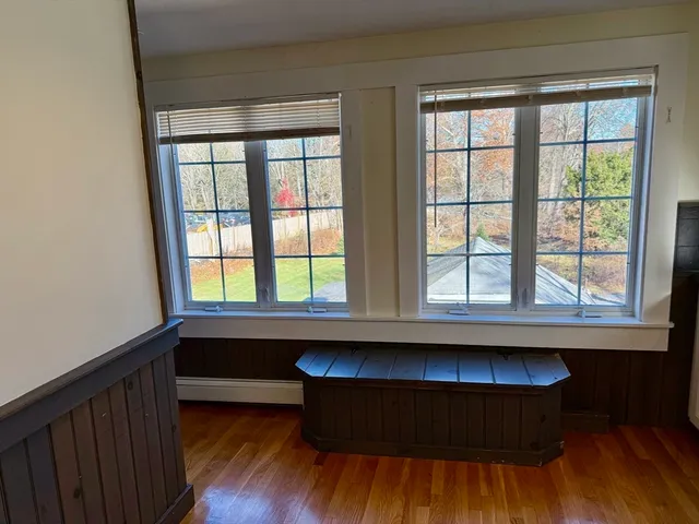 a room with wooden floors and a window