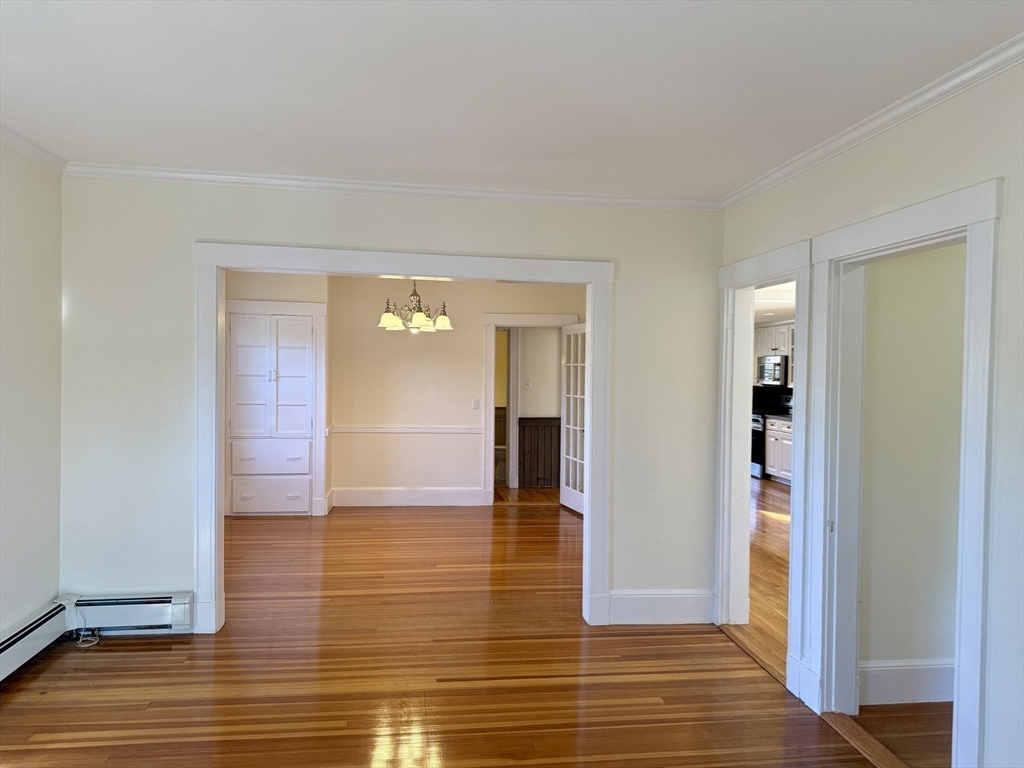 24 State Street, Unit 2 Wellesley, MA 02482 - Photo 8 of 21 a view of a hallway with wooden floor and a bathroom