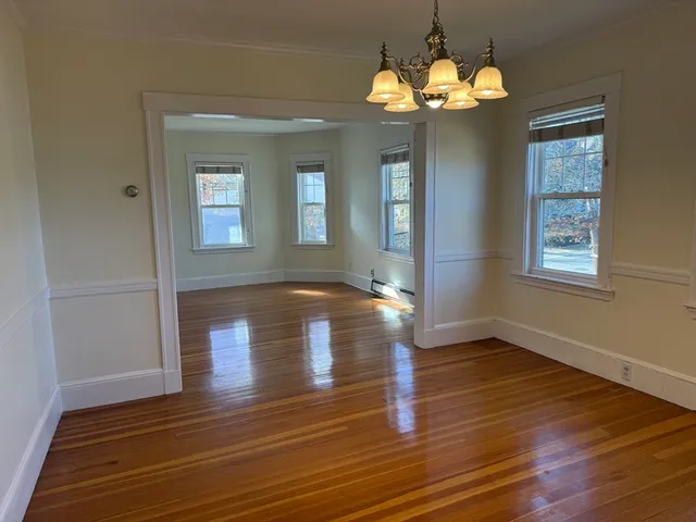 a view of livingroom with window wooden floor and a chandelier