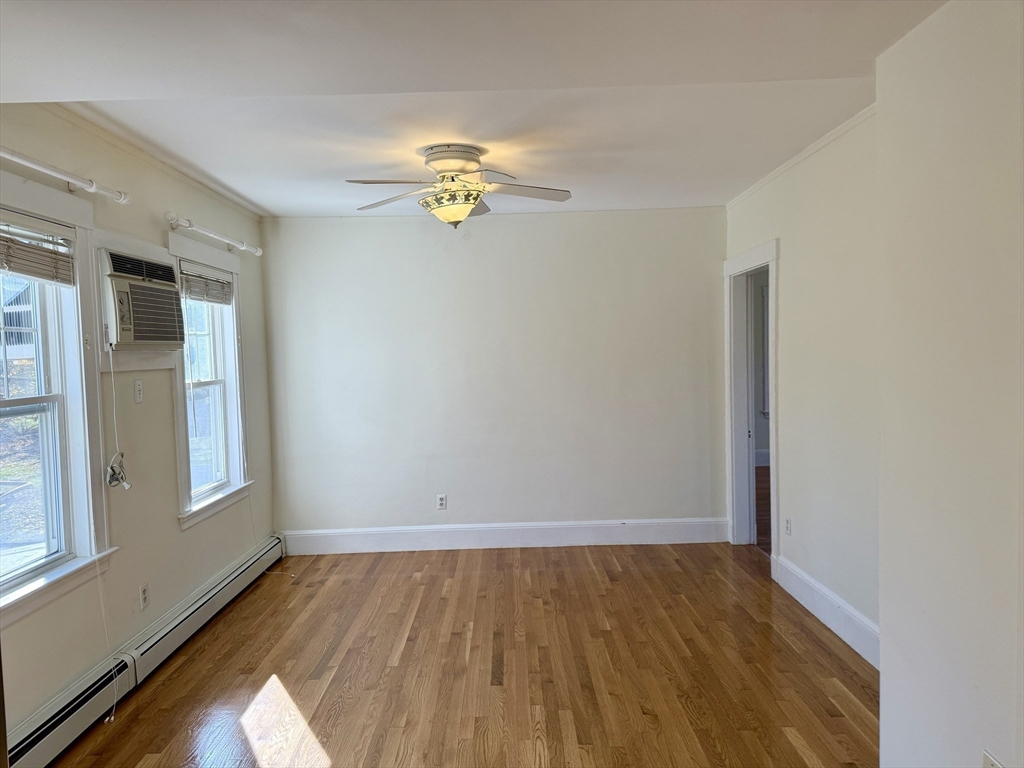 24 State Street, Unit 2 Wellesley, MA 02482 - Photo 10 of 21 a view of a room with wooden floor and window