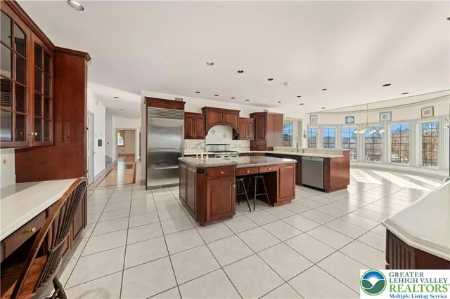 a kitchen with stainless steel appliances a stove a sink a oven and a refrigerator