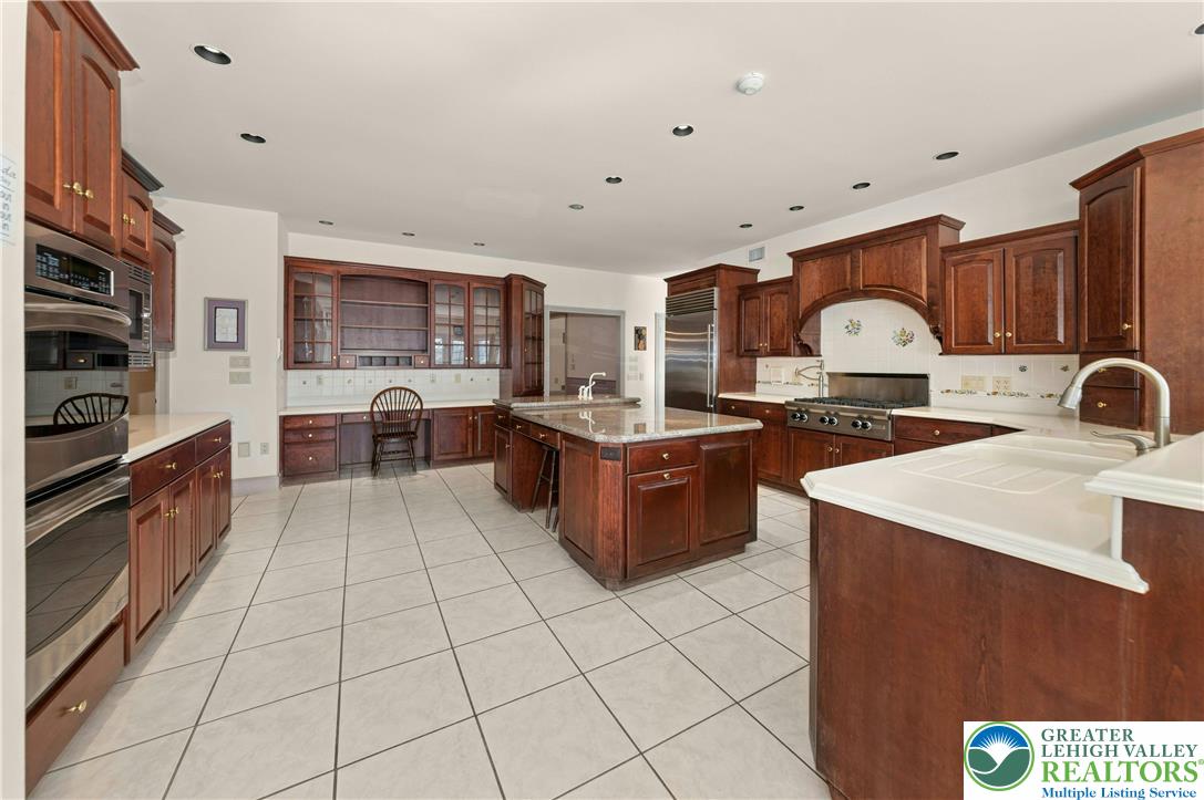 3640 Manor Road Bethlehem, PA 18020 - Photo 13 of 36 a kitchen with stainless steel appliances granite countertop a stove a sink and a microwave