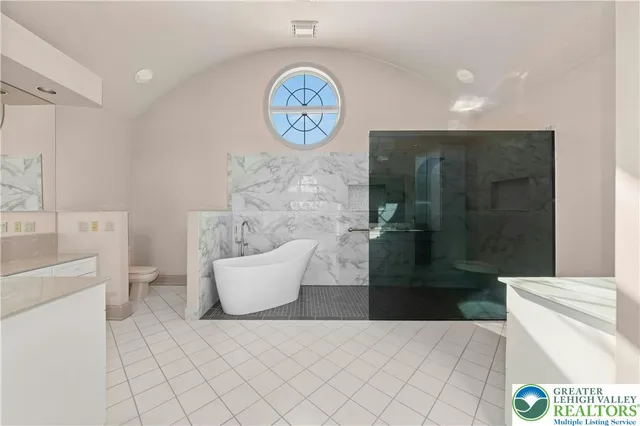 a bathroom with a bathtub and a shower
