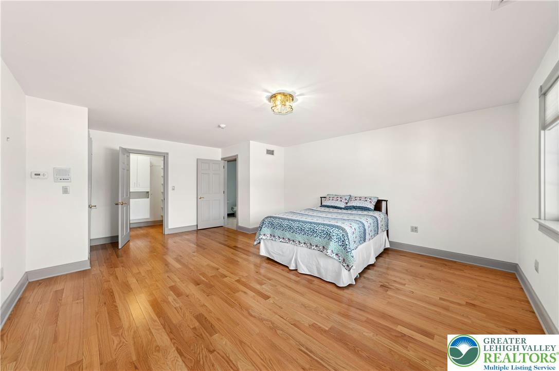 3640 Manor Road Bethlehem, PA 18020 - Photo 27 of 36 a spacious bedroom with a bed and wooden floor