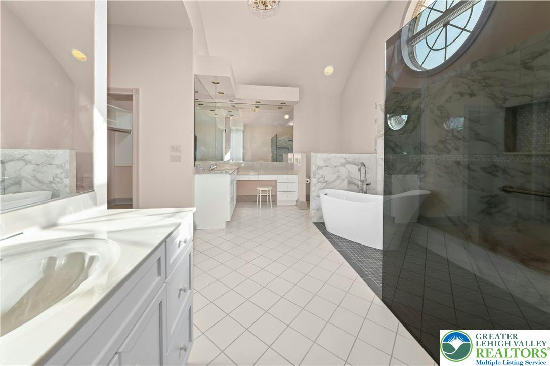 3640 Manor Road Bethlehem, PA 18020 - Photo 31 of 46 a bathroom with a sink a mirror and a bathtub