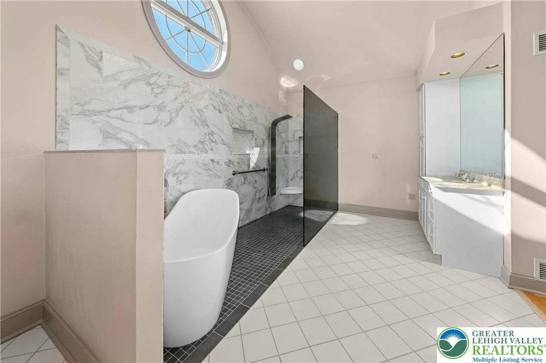 3640 Manor Road Bethlehem, PA 18020 - Photo 32 of 46 a en suite bathroom with a granite countertop sink and a mirror