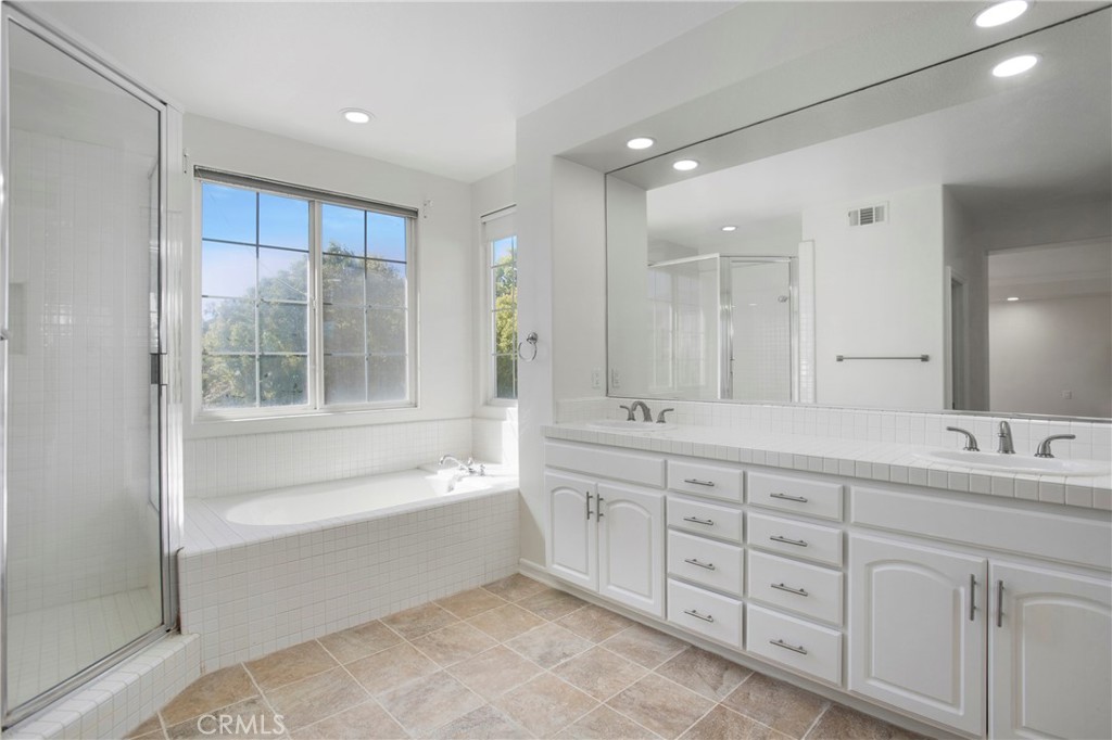 68 Bridgeport Road Newport Coast, CA 92657 - Photo 17 of 27 a spacious bathroom with a double vanity sink a mirror and a bathtub