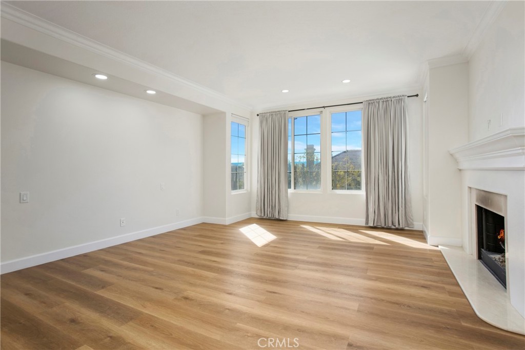 68 Bridgeport Road Newport Coast, CA 92657 - Photo 19 of 27 a view of an empty room with a fireplace and a window