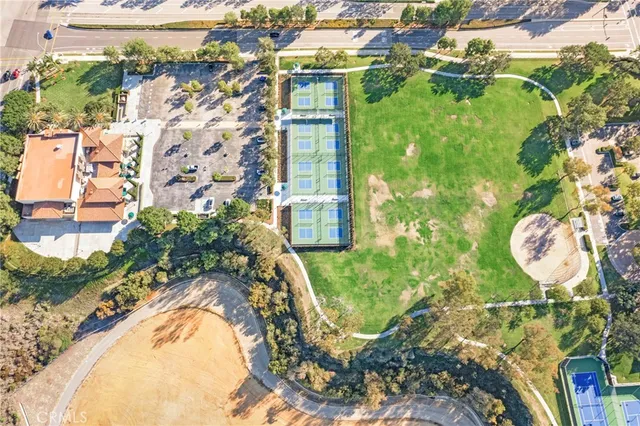 a view of a swimming pool with a yard and plants