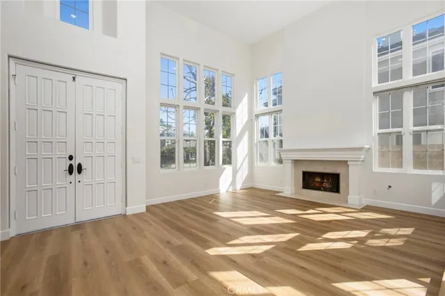 a view of an empty room with window and fire place