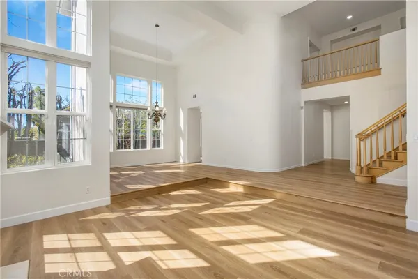 a view of a livingroom with wooden floor and a window