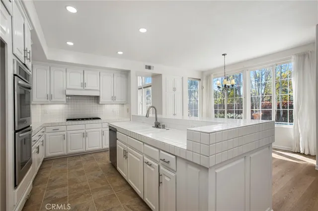 a kitchen with sink stove and cabinets