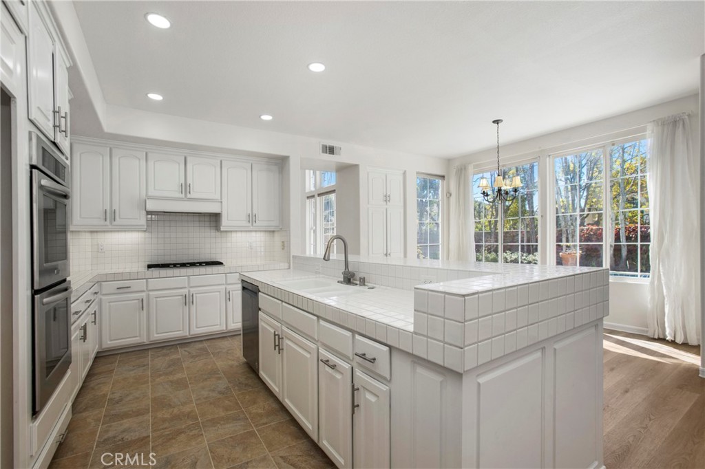 68 Bridgeport Road Newport Coast, CA 92657 - Photo 9 of 27 a kitchen with sink stove and cabinets