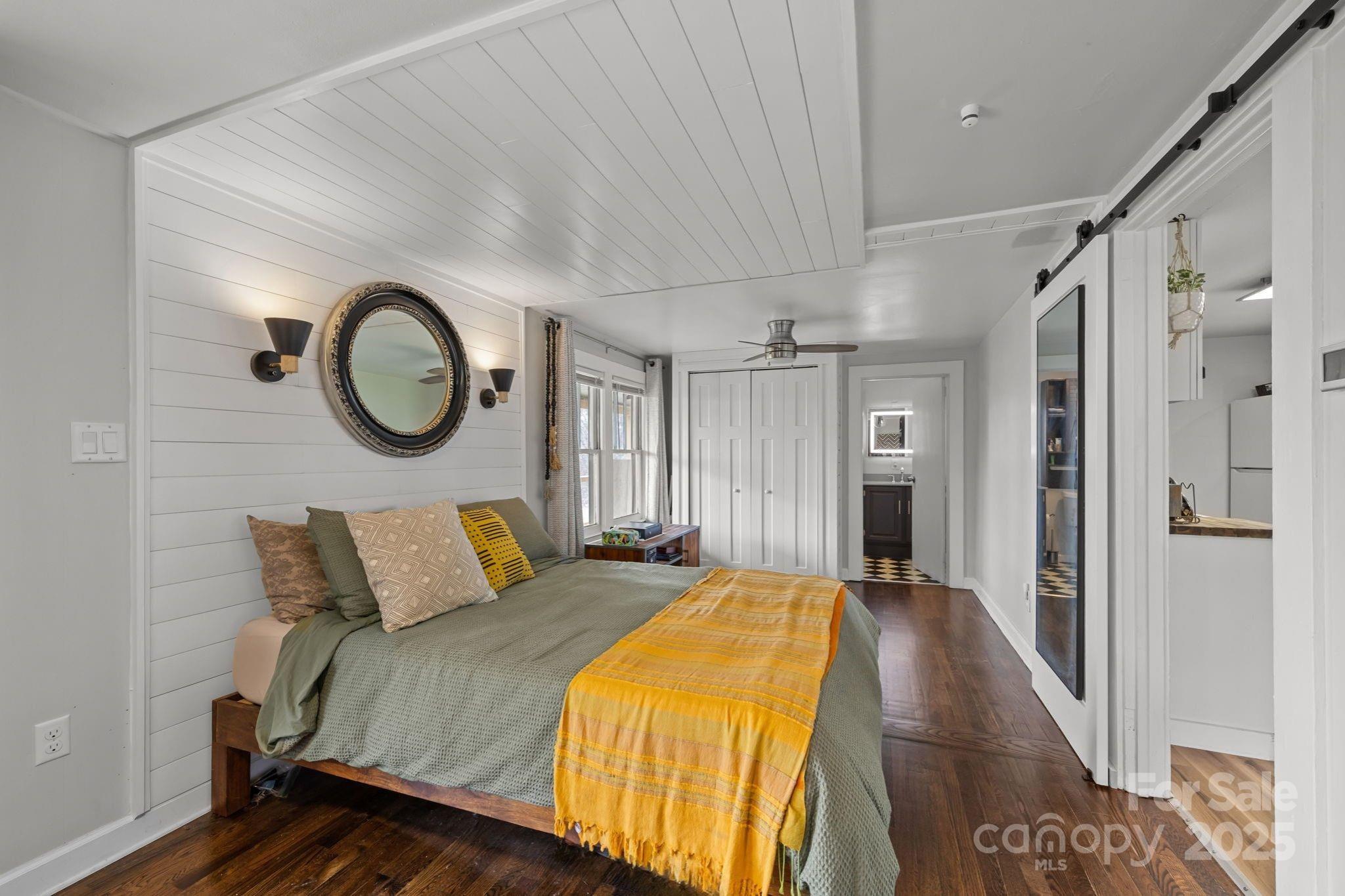 731 Don Felmet Road Marshall, NC 28753 - Photo 14 of 23 a bedroom with a bed and a chandelier