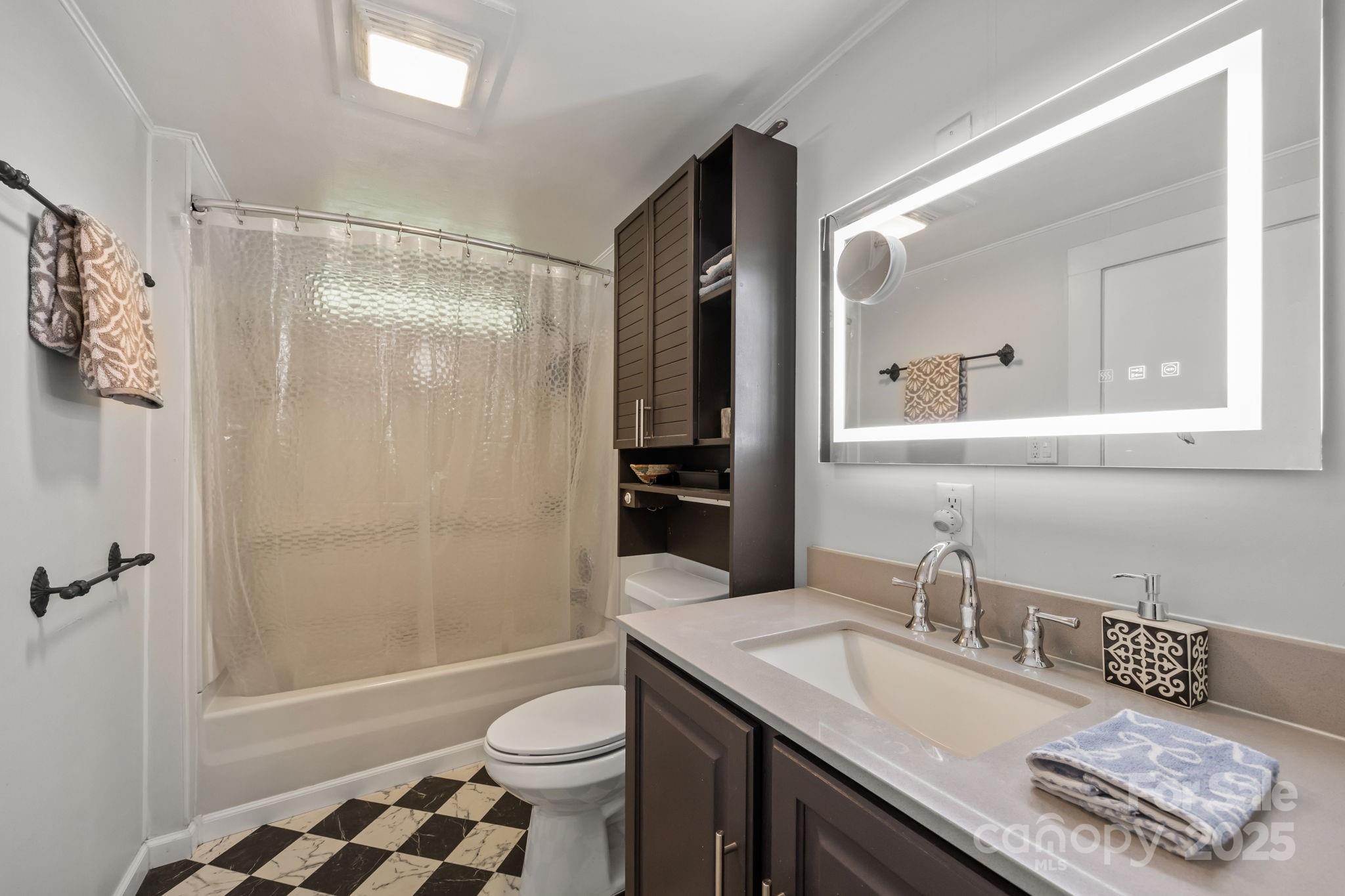 731 Don Felmet Road Marshall, NC 28753 - Photo 15 of 23 a bathroom with a granite countertop sink toilet a mirror a vanity and shower
