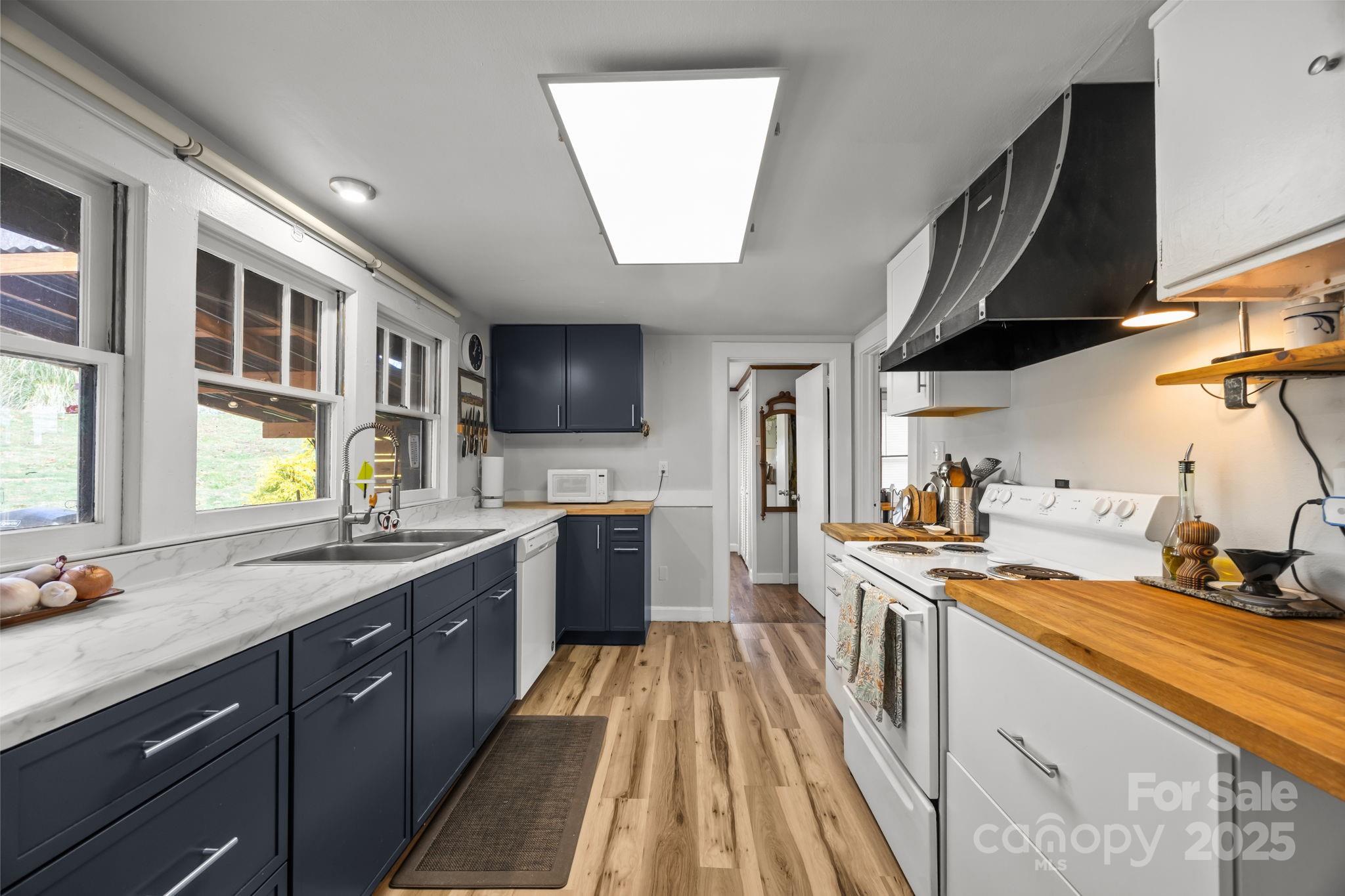 731 Don Felmet Road Marshall, NC 28753 - Photo 3 of 23 a kitchen with a sink stove and cabinets