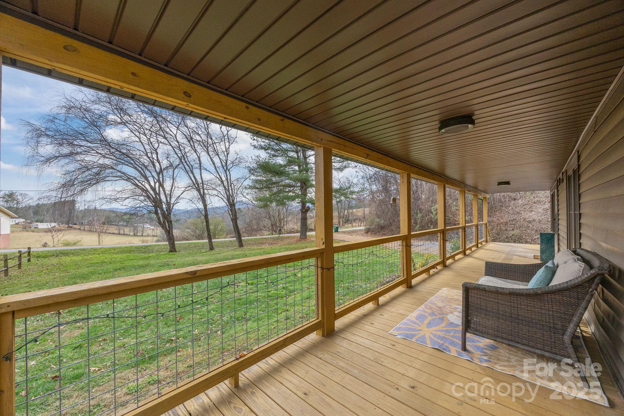 731 Don Felmet Road Marshall, NC 28753 - Photo 4 of 23 a balcony with wooden floor and outdoor seating