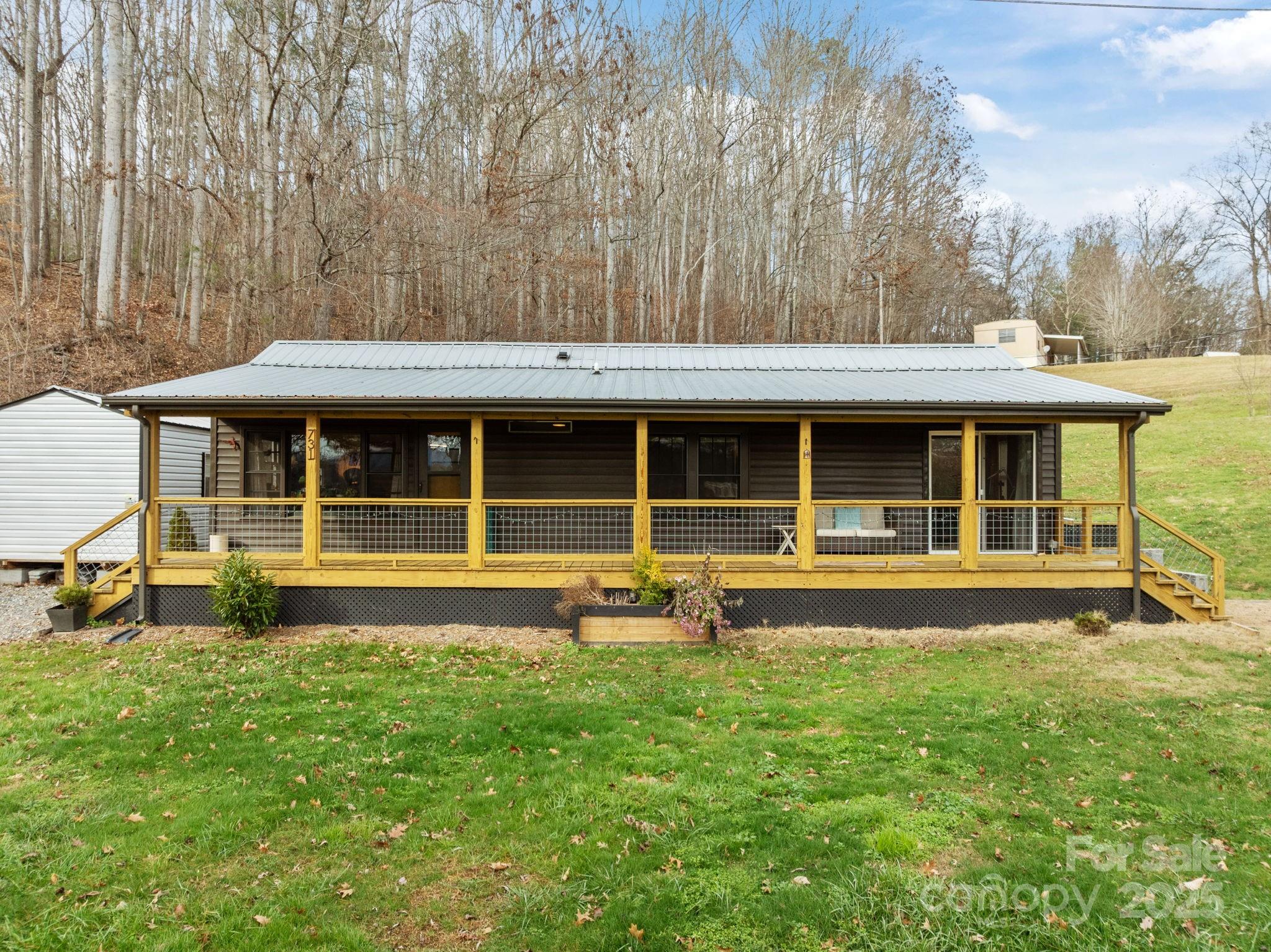 731 Don Felmet Road Marshall, NC 28753 - Photo 6 of 23 a house view with a sitting space and garden