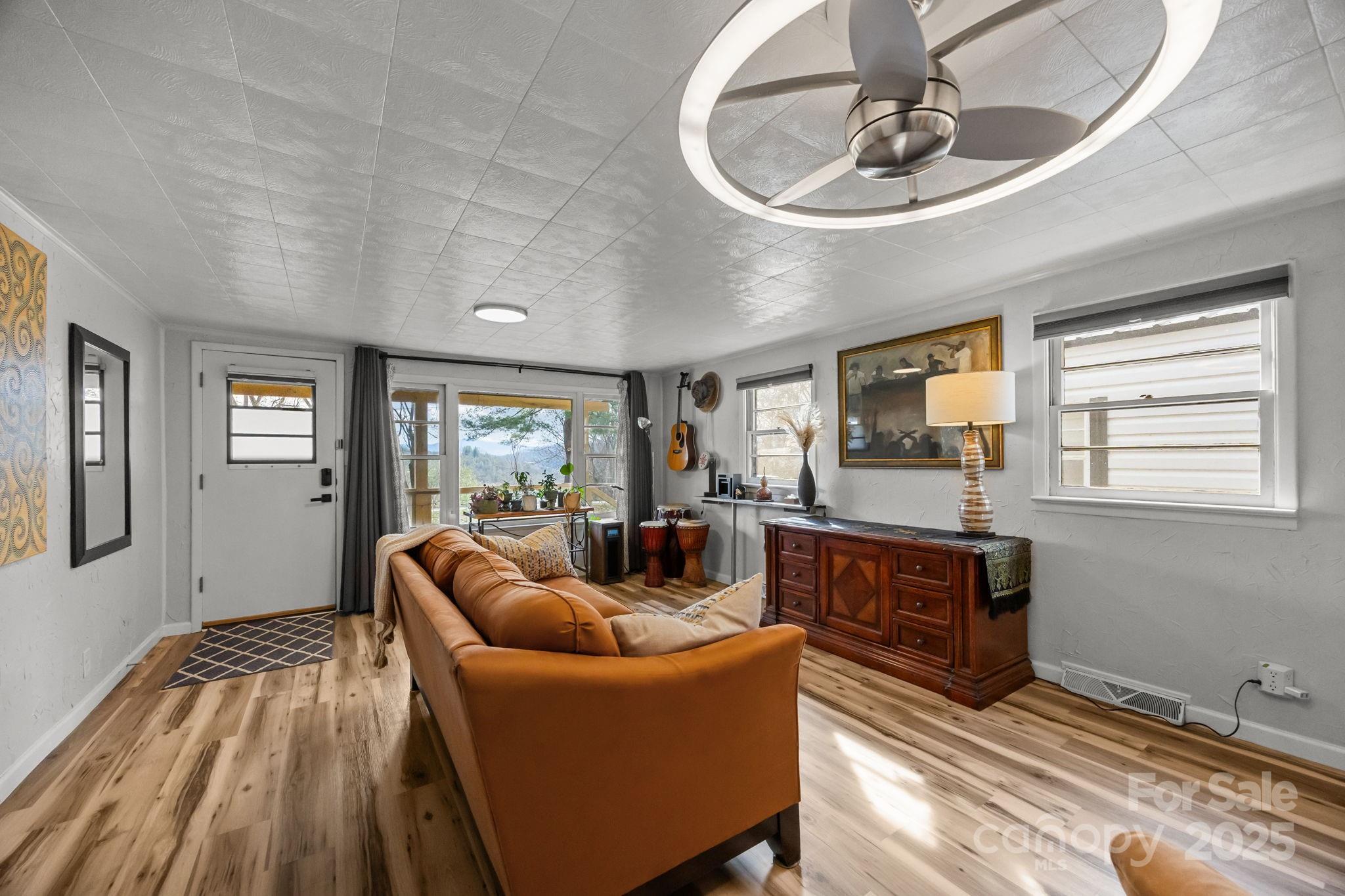 731 Don Felmet Road Marshall, NC 28753 - Photo 8 of 23 a living room with furniture and a wooden floor